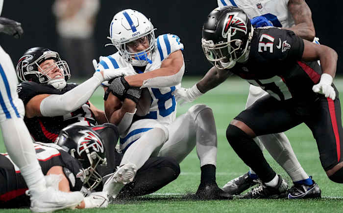 Indianapolis Colts running back Jonathan Taylor (28) is brought down by Atlanta Falcons defenders during a game against at Mercedes-Benz Stadium.